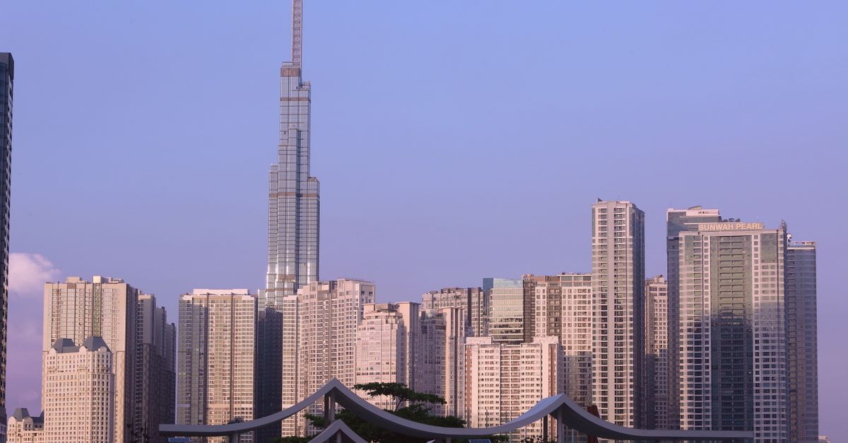 A wide-angle cityscape of a Southeast Asian metropolis at dusk, dense office towers and glowing windows, hazy warm light, no visible writing or sign, cinematic depth, sense of rapid digital growth and regulatory ambiguity