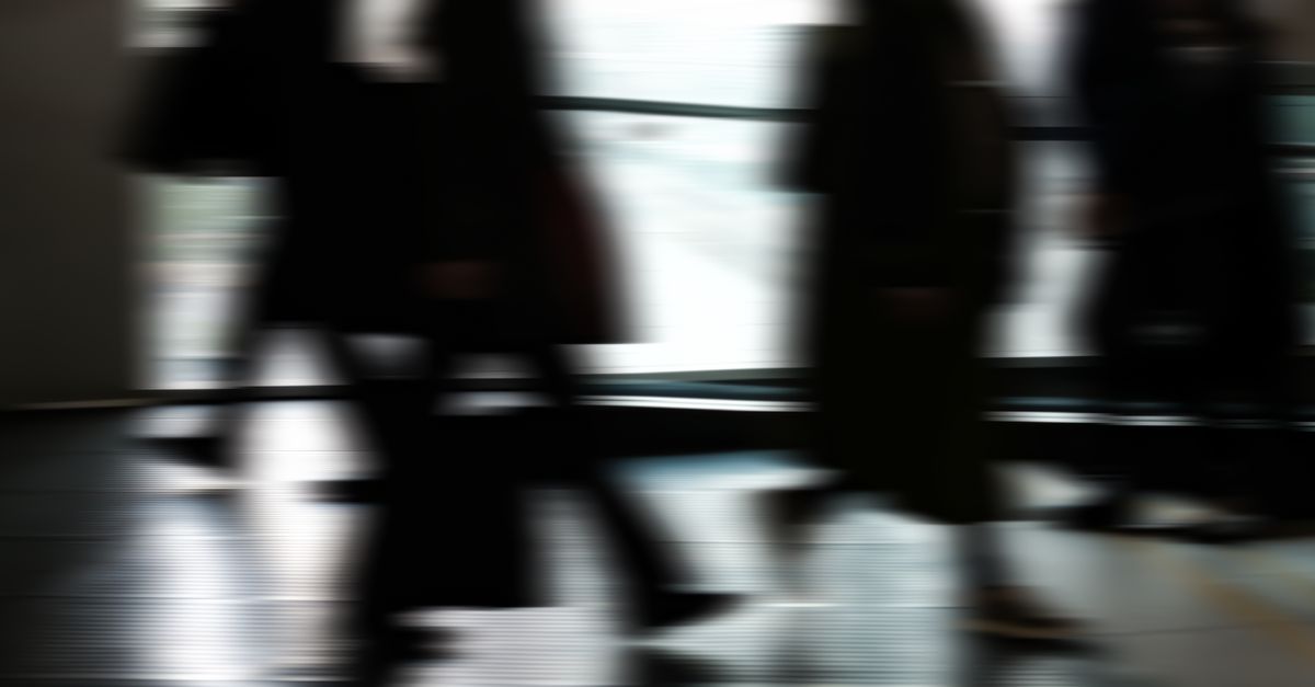 A wide-angle, cinematic view of a modern financial trading floor merging with a shadowy government office interior, abstract digital network lines in blue and green overlaying the scene, representing cybersecurity and global currency, no visible detail or logos.